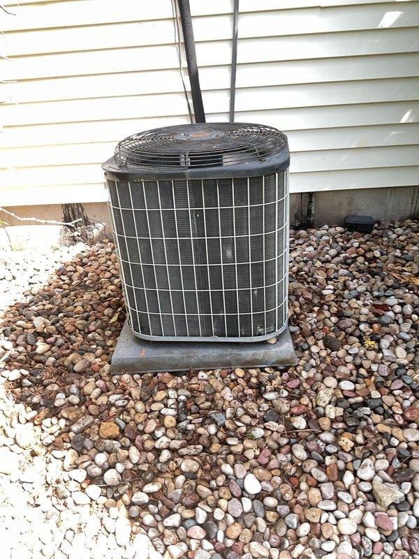 Performed comprehensive inspection and maintenance on outdoor air conditioning condenser unit. System was found to be low on refrigerant and operating with reduced efficiency due to accumulated dirt and debris on condenser coils. Rinsed down condenser coils to remove buildup, replaced air filter, and recharged system with appropriate amount of Freon to manufacturer specifications. Unit failed initial inspection due to refrigerant deficiency and contaminated components but was restored to operational status following service completion.