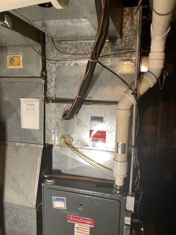 Responded to no cooling complaint on residential air conditioning system. Diagnosed failed compressor with system running but not producing cold air. Additionally identified faulty door control switch on Goodman furnace unit. Recommended complete compressor replacement due to component failure.