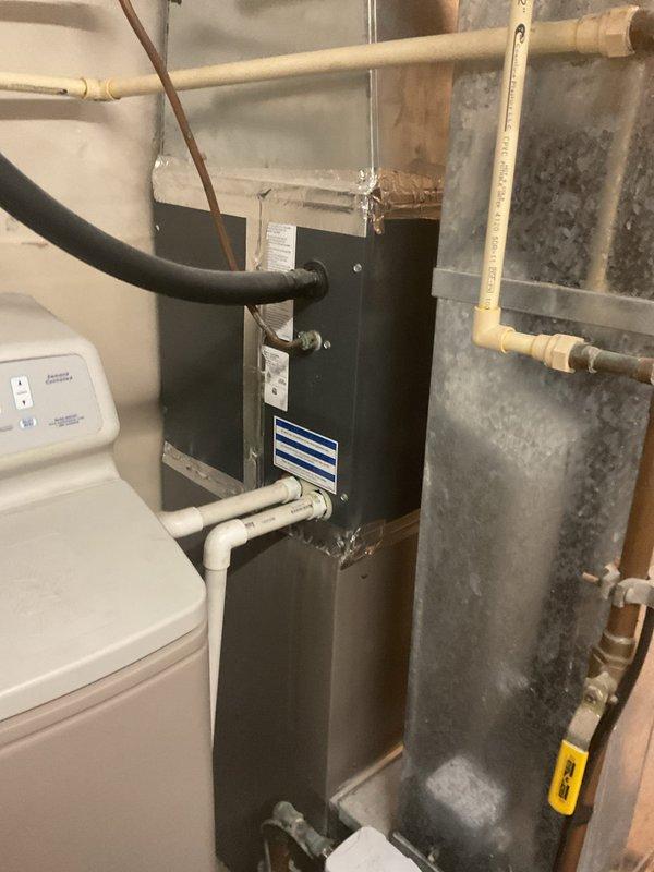Performed comprehensive air conditioning clean and check service on residential HVAC system located in basement mechanical room. Inspected air handler unit, verified proper operation of all components, and cleaned system as needed. Confirmed thermostat functionality and system controls operating within normal parameters.