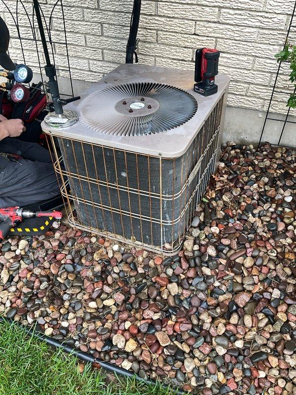 Responded to no cooling complaint on residential air conditioning system. Upon arrival, found unit had previously frozen and was experiencing inadequate cooling performance. Connected manifold gauges to outdoor condensing unit and performed refrigerant pressure diagnostics. Testing revealed system was low on refrigerant charge, indicating a leak in the refrigerant circuit. Due to the age and condition of the equipment, along with the refrigerant loss, recommended full system replacement rather than repair. Customer was advised to monitor unit and power off if freezing occurs again to prevent compressor damage.