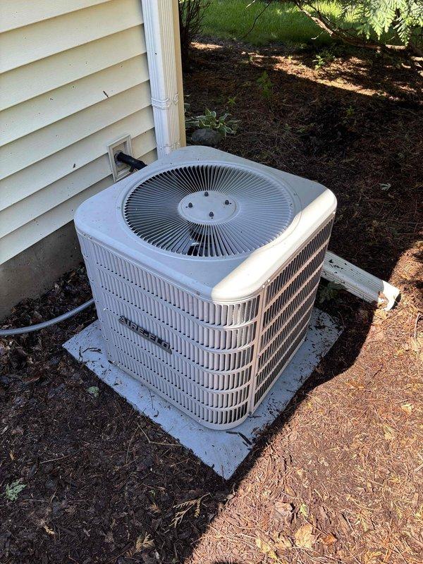 Performed seasonal A/C clean and check on residential condensing unit prior to cooling season startup. Found condenser coil heavily soiled with dirt and debris accumulation. Thoroughly cleaned condenser coil interior and exterior surfaces, removed debris from unit housing, and verified proper airflow through louvered panels. Checked system pressures and temperatures using manifold gauges, confirming refrigerant charge and system operation within manufacturer specifications. Unit operational and ready for cooling season.
