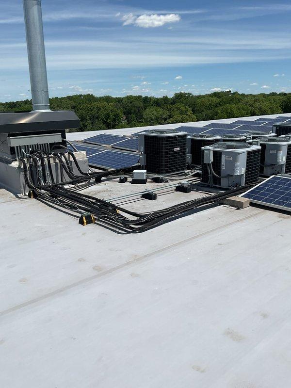 Responded to water leak complaint with AC unit discharging onto roof membrane. Found pressure tap (PT) traps completely plugged, preventing proper condensate drainage. Cleared and cleaned PT traps, restored drainage flow, and cycled unit to verify proper operation and confirm leak resolution.