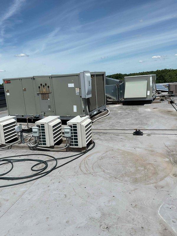 Responded to water leak complaint with AC unit discharging onto roof membrane. Found pressure tap (PT) traps completely plugged, preventing proper condensate drainage. Cleared and cleaned PT traps, restored drainage flow, and cycled unit to verify proper operation and confirm leak resolution.