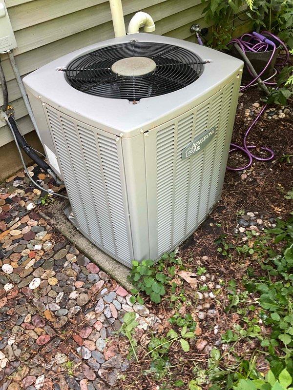 # HVAC Tune-Up Completed

Performed comprehensive air conditioning tune-up on Armstrong outdoor condenser unit. Upon arrival, found condenser coils heavily soiled with debris accumulation restricting airflow. Thoroughly cleaned condenser coils and removed dirt, leaves, and vegetation buildup from unit exterior and surrounding area. Completed full system inspection verifying proper operation of all components including fan motor, electrical connections, and refrigerant lines. Unit restored to optimal operating condition.