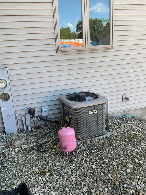 # HVAC Service Call - No Cooling Complaint

Responded to service call for York air conditioning unit not producing cold air. Upon arrival, conducted diagnostic assessment of 10+ year old system experiencing cooling failure.

## Diagnostic Findings

Connected Fieldpiece SMAN refrigerant manifold gauge set to service ports to evaluate system pressures and temperatures. Recorded operating pressures of 116.2 psig on low side and 207.5 psig on high side. Multiple temperature readings captured including 103°F ambient, with superheat reading of 38.1°F and subcooling of 88.8°F. These readings indicated abnormal operating conditions requiring further investigation.

## Work Performed

Performed comprehensive system evaluation including:
- Refrigerant pressure testing on both high and low side service ports
- Temperature differential measurements across evaporator coil
- Superheat and subcooling calculations to determine refrigerant charge status
- Visual inspection of outdoor condensing unit fo
