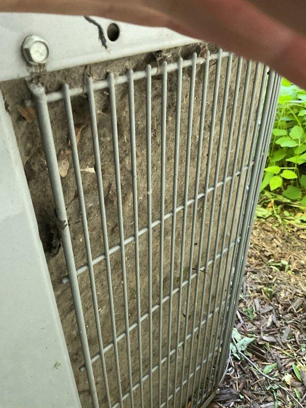 Performed comprehensive air conditioning tune-up on outdoor condenser unit. Replaced failed capacitor, cleaned heavily soiled condenser coils with significant dirt and debris accumulation, and removed obstructions including bird nest from unit. Added refrigerant to correct low charge level, installed fresh air filter, and washed down entire unit. System inspected and passed operational testing, meeting all performance standards required for state survey compliance.