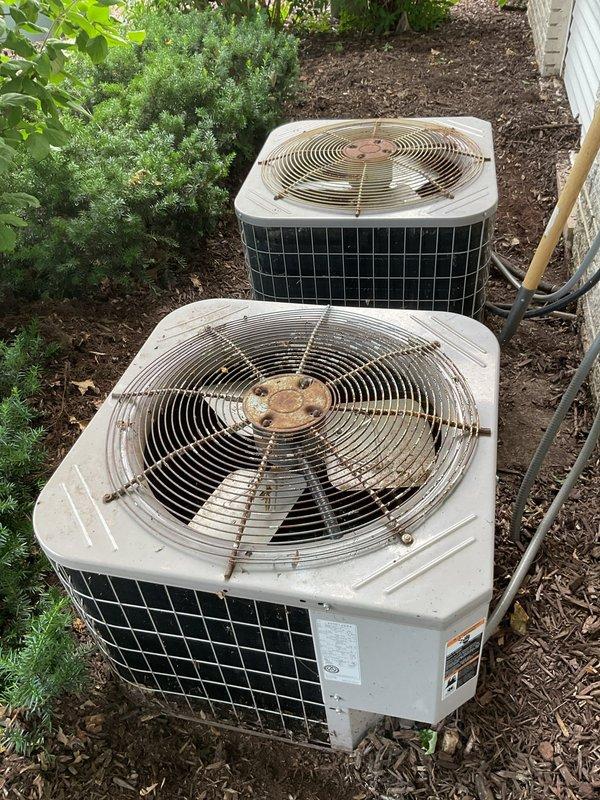 Responded to no cooling complaint on 27-year-old residential air conditioning system. Found outdoor condenser unit partially covered with landscaping mulch from recent yard work, which was cleaned and removed from equipment. Performed diagnostic testing and determined unit was significantly low on refrigerant charge. Due to advanced age of system and extent of refrigerant loss, recommended complete system replacement rather than repair, as unit has exceeded its expected service life and continued repairs would not be cost-effective.