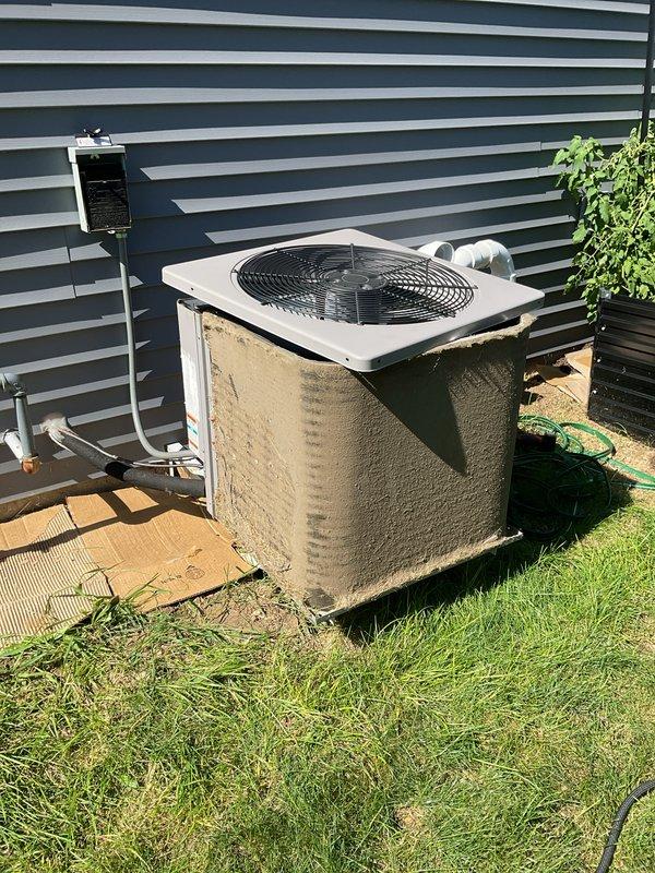 Responded to no cooling complaint on residential air conditioning system. Upon arrival, found outdoor condenser unit with visible weathering and dirt accumulation on exterior panels. Performed diagnostic evaluation of system components including refrigerant lines, electrical disconnect, and condenser operation. Reviewed thermostat troubleshooting documentation and verified proper system communication. Identified issue preventing cooling mode activation and completed necessary repairs to restore normal operation.