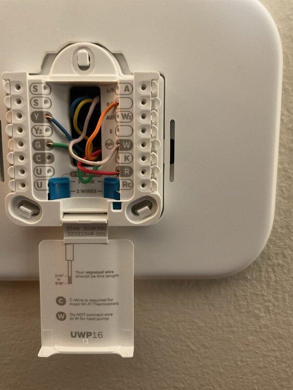 Responded to no cooling call on 19-year-old furnace system. Upon arrival, diagnosed failed thermostat preventing air conditioning operation. Removed existing malfunctioning thermostat and installed new Honeywell T200 programmable thermostat. Verified proper wire terminations at terminal block including R, C, Y, G, and W connections. Tested system operation and confirmed successful cooling cycle engagement. System restored to full operational status.