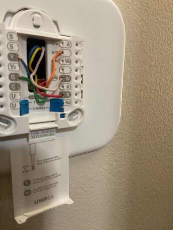 Responded to no cooling call on 19-year-old furnace system. Upon arrival, diagnosed failed thermostat preventing air conditioning operation. Removed existing malfunctioning thermostat and installed new Honeywell T200 programmable thermostat. Verified proper wire terminations at terminal block including R, C, Y, G, and W connections. Tested system operation and confirmed successful cooling cycle engagement. System restored to full operational status.