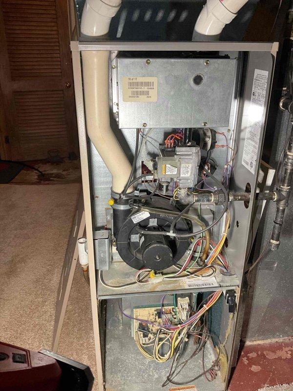 Performed comprehensive furnace tune-up and safety inspection on 20+ year old gas heating unit. During internal examination, discovered compromised heat exchanger with visible holes, creating an immediate safety hazard due to potential carbon monoxide exposure. Documented findings with photographs showing internal components, burner assembly, blower motor, and overall unit condition. Advised homeowner of critical failure requiring immediate unit replacement rather than continued operation. Submitted lead request for new furnace installation to address safety concerns and prevent system failure during heating season.