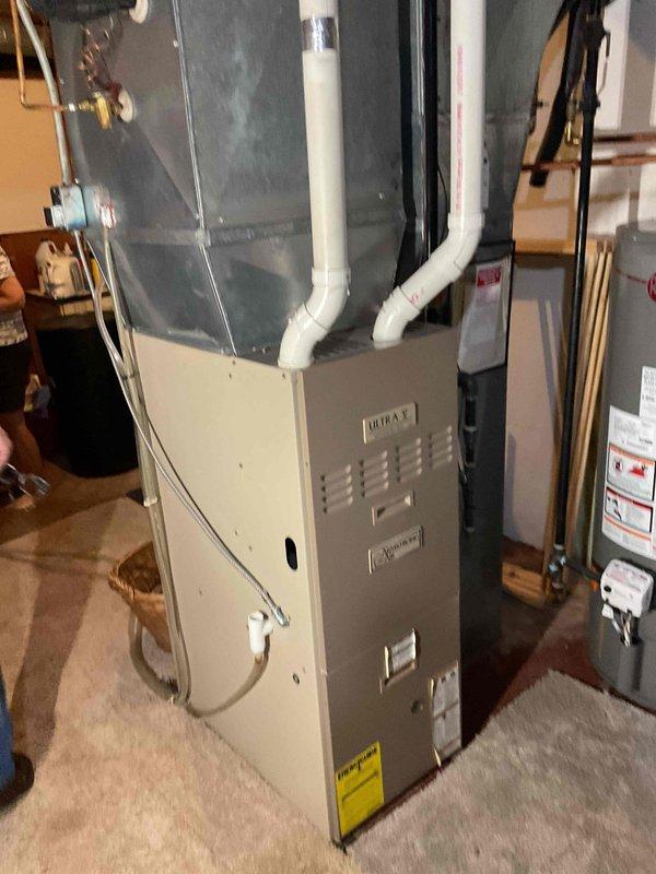 Performed comprehensive furnace tune-up and safety inspection on 20+ year old gas heating unit. During internal examination, discovered compromised heat exchanger with visible holes, creating an immediate safety hazard due to potential carbon monoxide exposure. Documented findings with photographs showing internal components, burner assembly, blower motor, and overall unit condition. Advised homeowner of critical failure requiring immediate unit replacement rather than continued operation. Submitted lead request for new furnace installation to address safety concerns and prevent system failure during heating season.