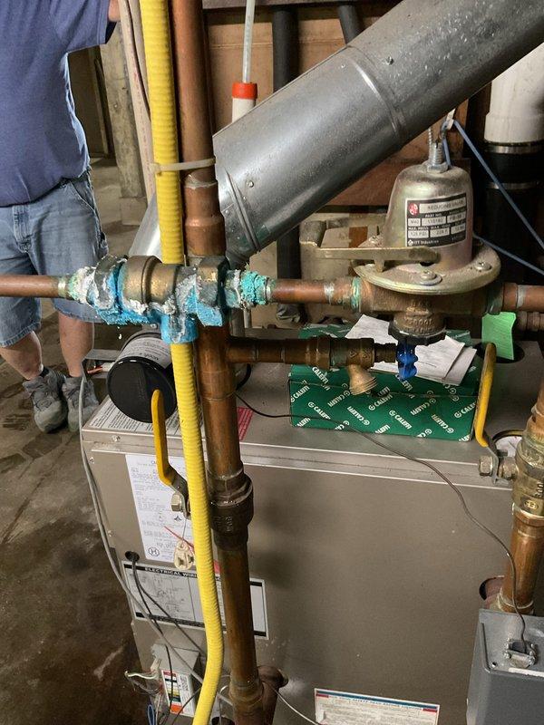 Responded to service call for boiler system with active water leaks. Upon inspection, identified multiple compromised pipes showing severe corrosion and deterioration, particularly on vertical supply lines and connection points. The corroded piping exhibited significant rust and oxidation, creating multiple leak points that threatened system integrity and efficiency.

Removed all affected leaking pipes and corroded fittings from the boiler assembly. Installed new black iron pipe and fittings to replace the deteriorated components, ensuring proper threading and secure connections throughout the system. All new piping was installed to code specifications with appropriate support and routing to prevent future stress points.

Tested system for leaks and verified proper operation upon completion. All connections sealed properly with no active leaks detected. System restored to full operational capacity.