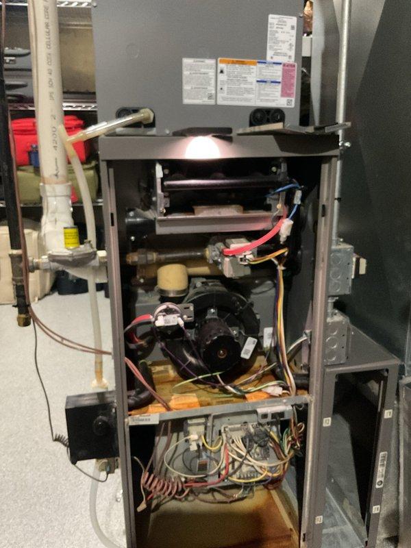 Completed comprehensive tune-up service on two furnaces in a multi-zone system. Performed standard maintenance including cleaning flame sensors, inspecting blower fans, tightening electrical connections, replacing air filters, blowing out drain traps, and inspecting pressure switch openings. Tested igniter on both units and replaced one igniter due to excessive ohm rating. Verified carbon monoxide levels were within acceptable range at 8 ppm on first unit and 24 ppm on second unit. Both furnaces achieved proper Delta T readings in the 70-degree range. Conducted heat exchanger inspection using scope due to zoning system concerns and confirmed no cracks or holes present. Documented need for zone control system upgrade and four smart thermostats to resolve existing zoning issues.
