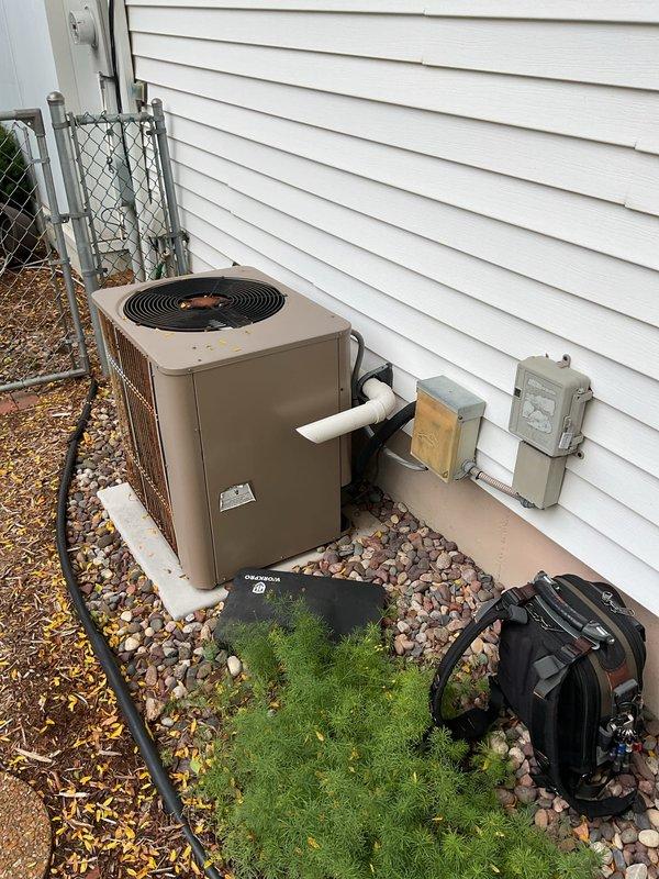 Performed comprehensive clean and check service on 2003 Lennox furnace and air conditioning system. Inspected internal blower assembly, electrical connections, and control mechanisms on furnace unit with access panel removed for thorough examination. Evaluated outdoor condenser unit, fan operation, and electrical disconnect components, confirming proper system function on both heating and cooling equipment.