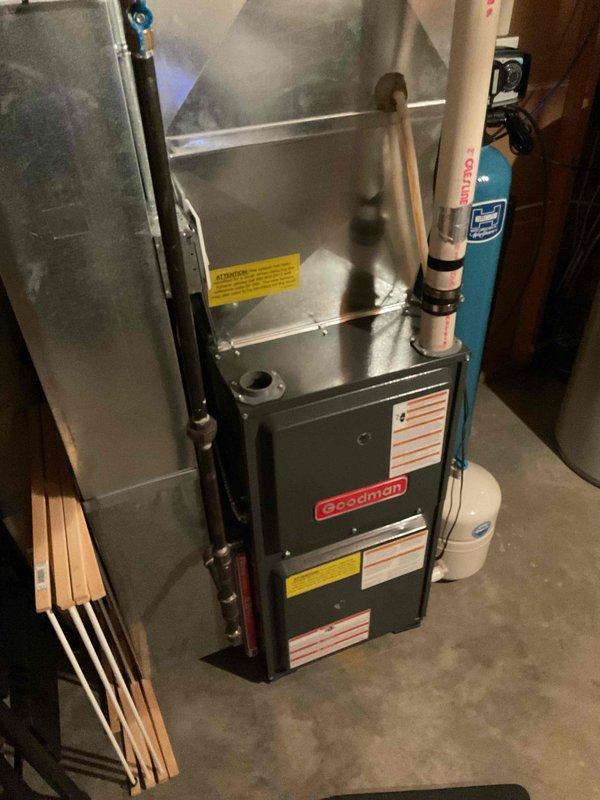 Completed comprehensive furnace maintenance and safety inspection on Goodman heating unit. Verified igniter resistance at 49.9 ohms within specification, confirmed blower motor operation with free rotation, and measured combustion efficiency at 8 ppm CO with temperature rise of 48°. Performed cleaning of flame sensor, removed and flushed drain trap, inspected and tightened all electrical connections, and blew out pressure switch and ports which were found in clean condition from previous winter replacement. Confirmed thermostat communication and verified system heating operation upon completion.