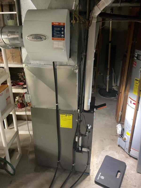 Performed comprehensive furnace maintenance including cleaning and inspection of all major components. Tested igniter at 54 ohms, cleaned flame sensor, and addressed moderate rust buildup on burners. Removed and cleaned condensate drain trap which contained accumulated debris, then blew out cold air return and header box. Inspected and cleared pressure switch ports, verified blower fan operation, and tightened electrical connections on control board. Confirmed CO output at 13 ppm, verified Aprilaire humidifier pads in acceptable condition, and noted filter recently changed. All systems operating within normal parameters upon completion.