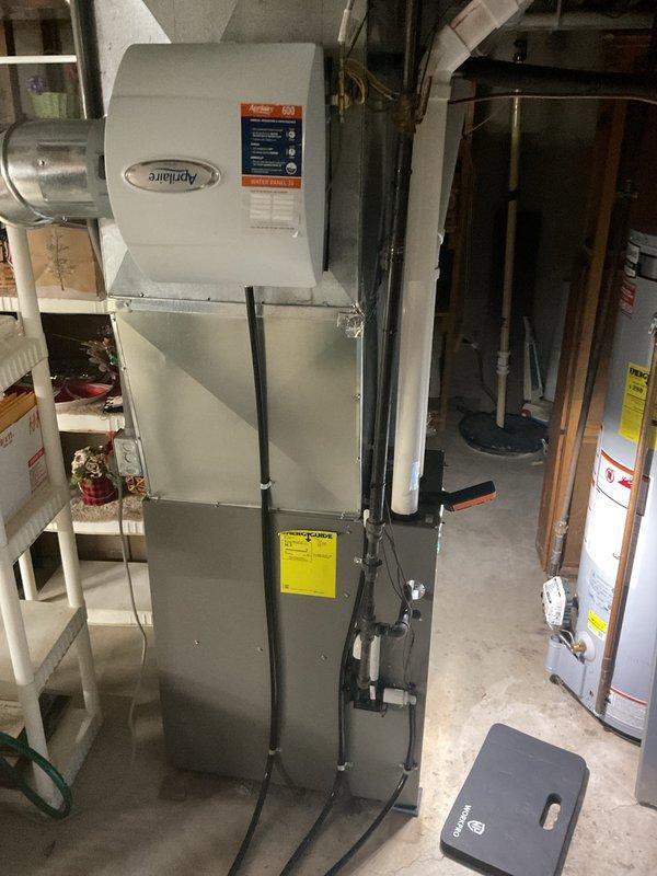 Performed comprehensive furnace maintenance including cleaning and inspection of all major components. Tested igniter at 54 ohms, cleaned flame sensor, and addressed moderate rust buildup on burners. Removed and cleaned condensate drain trap which contained accumulated debris, then blew out cold air return and header box. Inspected and cleared pressure switch ports, verified blower fan operation, and tightened electrical connections on control board. Confirmed CO output at 13 ppm, verified Aprilaire humidifier pads in acceptable condition, and noted filter recently changed. All systems operating within normal parameters upon completion.