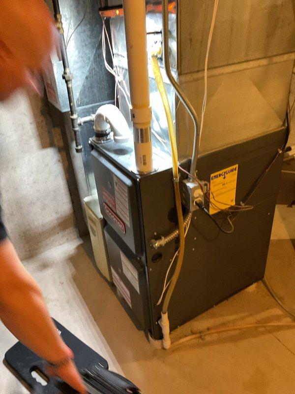 Completed comprehensive furnace maintenance including igniter resistance testing (47.8 ohms), flame sensor cleaning, and verification of proper blower motor operation. Removed and cleaned condensate drain trap to address minor buildup, blew out collector box and header box, cleaned pressure switch ports, and tightened electrical connections at control board. Unit operational testing confirmed appropriate heating operation with low-stage carbon monoxide output at 9 ppm, and replaced thermostat batteries to ensure system reliability.