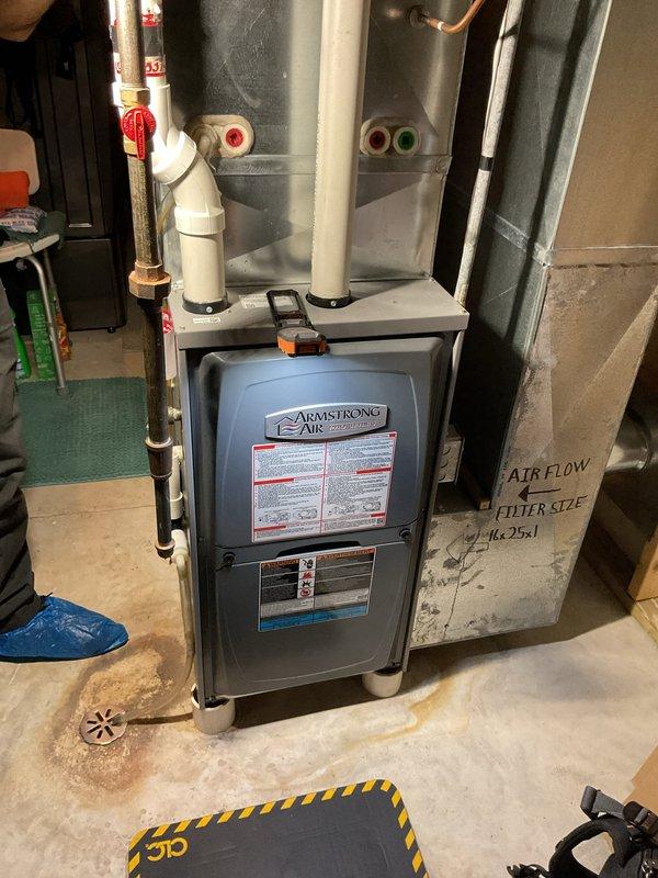Completed furnace clean and check on Armstrong Air unit. System operating and heating effectively with igniter reading 53 ohms, blower fan spinning freely, and first stage CO output at 10 ppm. Removed and cleaned flame sensor, cleaned drain trap bottom, blew out coil and header box openings, and tightened electrical connections on control board. Noted pressure switch ports showing cracks and wear but unit functioning properly at this time. Adjusted gas pressure from 1.5 to 1.65 to improve performance, resulting in first stage delta T increase from 18° to 24°.