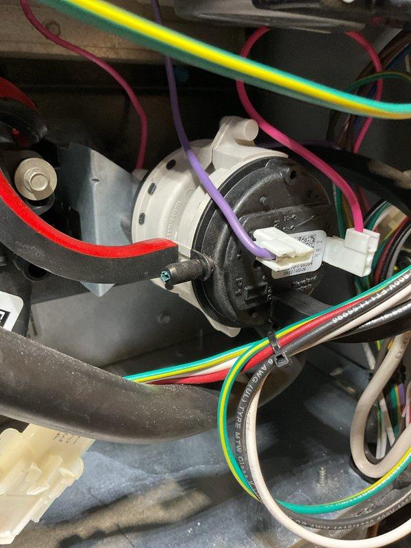 Completed furnace clean and check on Armstrong Air unit. System operating and heating effectively with igniter reading 53 ohms, blower fan spinning freely, and first stage CO output at 10 ppm. Removed and cleaned flame sensor, cleaned drain trap bottom, blew out coil and header box openings, and tightened electrical connections on control board. Noted pressure switch ports showing cracks and wear but unit functioning properly at this time. Adjusted gas pressure from 1.5 to 1.65 to improve performance, resulting in first stage delta T increase from 18° to 24°.