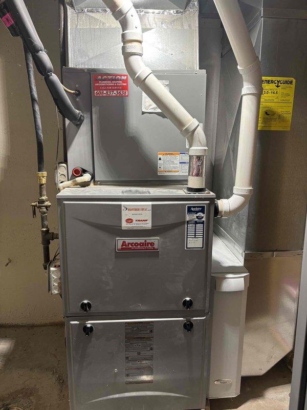 Completed prepaid furnace tune-up and maintenance on Arcoaire forced-air heating system. Performed comprehensive cleaning and operational check of furnace unit, verified proper function of all components, inspected gas connections and shut-off valve, and documented temperature differential readings showing supply air at 88.6°F and return air at -14.8°F. All systems operating within normal parameters with no deficiencies noted.