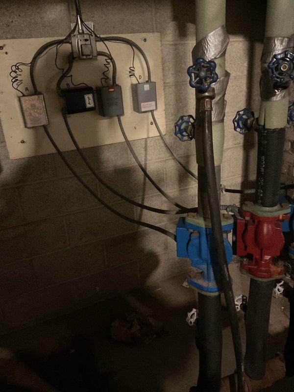 Relocated boiler water supply and return piping that was previously obstructing access to the electrical panel in the basement. Rerouted hydronic heating lines to a new position clear of the electrical equipment, ensuring proper clearance for code compliance and safe panel access. Reinstalled shutoff valves and circulator pump in the modified piping configuration, maintaining system integrity and functionality.