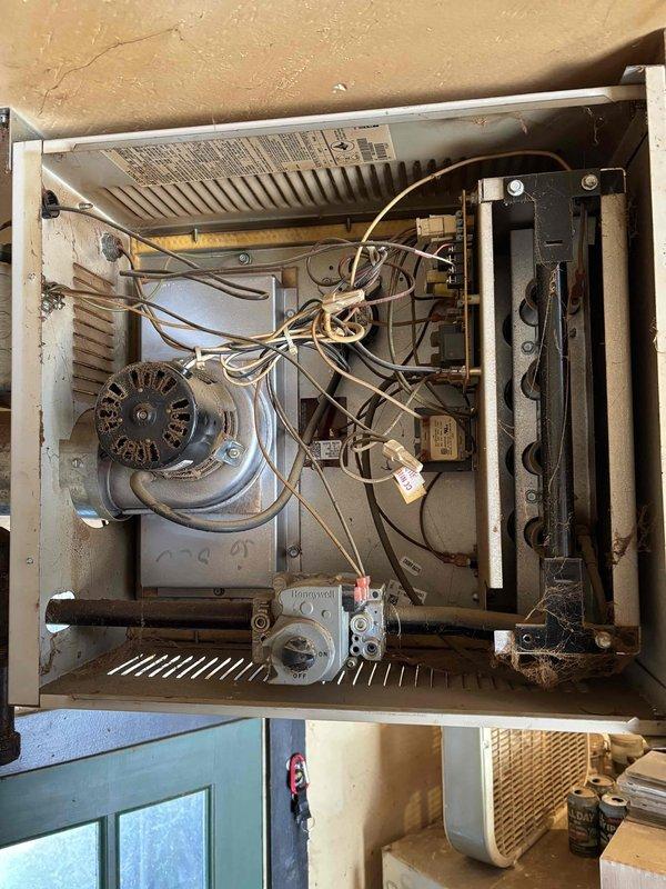 Responded to no heat call for Lennox garage heater unit. Diagnosed and confirmed failed induction motor preventing unit operation. Documented equipment condition and motor failure for customer records.