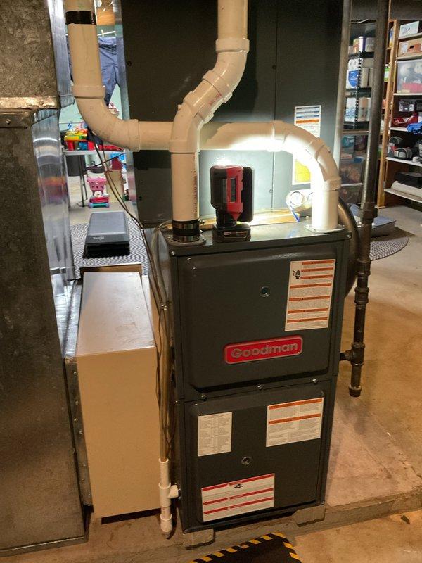 Responded to customer concern regarding unusual noise from A/C system and lack of drainage from condensate line. Upon inspection, determined noise was normal refrigerant flow through the low-pressure side of the system, not indicative of any malfunction. Performed basic clean and check service on Goodman furnace unit, verifying proper operation of all components. System found to be operating within normal parameters.