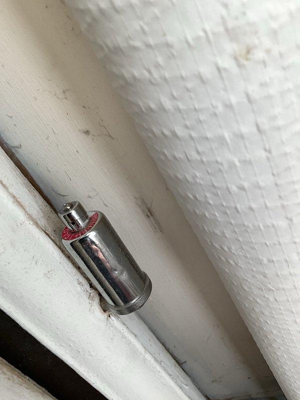 Performed maintenance and cleaning on boiler system with reported valve closure issue on living room heater zone. Cleaned burners and flame sensor, drained and refilled system to proper level, and inspected high limit controls for debris accumulation. Unable to complete full system testing due to inaccessible thermostat secured in lockbox; performed all accessible maintenance procedures and verified proper operation of burner assembly and safety controls.