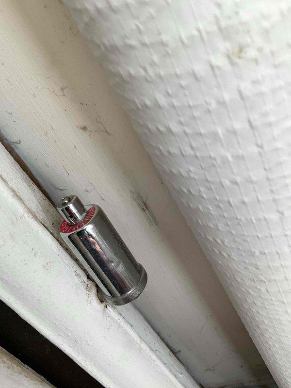 Performed maintenance and cleaning on boiler system with reported valve closure issue on living room heater zone. Cleaned burners and flame sensor, drained and refilled system to proper level, and inspected high limit controls for debris accumulation. Unable to complete full system testing due to inaccessible thermostat secured in lockbox; performed all accessible maintenance procedures and verified proper operation of burner assembly and safety controls.