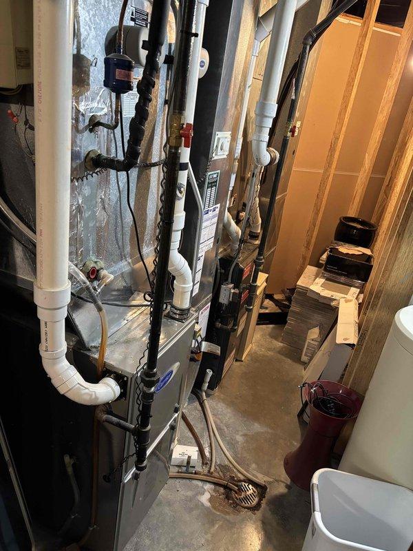 Responded to no cooling complaint following previous day's furnace maintenance. Upon arrival, found air conditioning system not operational. Inspected dual outdoor condenser units and indoor air handler in basement utility area. Diagnosed issue related to prior service visit. Restored power to AC system and verified proper operation of both condensers. Confirmed refrigerant lines, electrical connections, and thermostat communication functioning correctly. System returned to normal cooling operation.