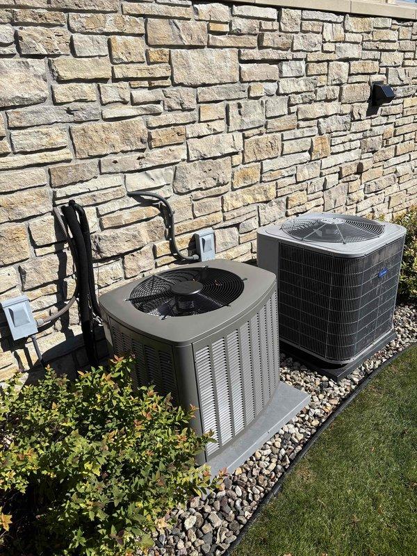 Responded to no cooling complaint following previous day's furnace maintenance. Upon arrival, found air conditioning system not operational. Inspected dual outdoor condenser units and indoor air handler in basement utility area. Diagnosed issue related to prior service visit. Restored power to AC system and verified proper operation of both condensers. Confirmed refrigerant lines, electrical connections, and thermostat communication functioning correctly. System returned to normal cooling operation.