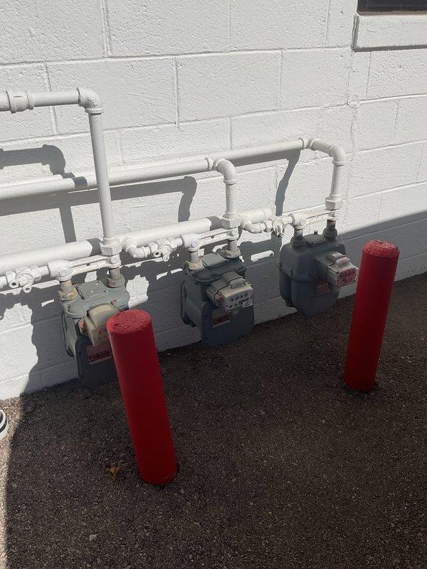 Responded to no heat call for wall-mounted Modine unit heater in shop. Upon arrival, found gas supply to building secured with lock on gas meter, preventing fuel delivery to unit. Documented meter condition and lock placement with photos. Advised customer that gas service must be restored by utility provider before unit can be serviced or operational testing performed.