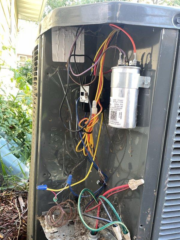 Responded to service call for A/C unit making excessive noise and short cycling. Upon inspection, found outdoor condensing unit with visible signs of age and wear, including dirt accumulation and corrosion in lower compartment. Accessed interior panel to diagnose issue. Examined capacitor, wiring connections, and electrical components. Multiple wire connections showed signs of looseness and deterioration at base of unit with rust stains present. Evaluated system using R-410A refrigerant charging chart specifications for proper subcooling levels and suction pressures. Identified failing capacitor and compromised wiring as primary causes of short cycling and noise complaints. Secured loose electrical connections, replaced defective capacitor, and cleaned interior compartment of debris and corrosion. Cycled unit through multiple operations to verify elimination of noise and proper run cycle restoration. System returned to normal operation with appropriate pressures and temperatures per ma