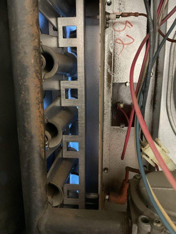 Responded to no-heat call for 2001 suspended furnace in shop area. Unit was short-cycling immediately after ignition due to faulty limit switch that would not reset. Diagnosed failed high-limit safety control preventing normal operation. Replaced defective limit switch and verified proper system operation with normal heating cycles restored.