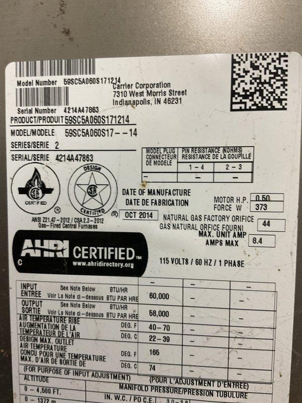 Responded to no-cool call on 10+ year old Carrier furnace where electrical breaker was tripping immediately upon system startup. Diagnosed blower motor with internal short circuit causing overcurrent condition. Removed failed blower motor assembly and installed replacement motor, restoring proper system operation without breaker trips.