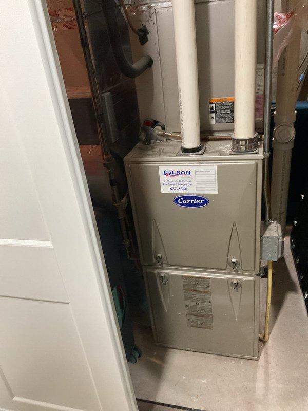 Responded to no-cool call on 10+ year old Carrier furnace where electrical breaker was tripping immediately upon system startup. Diagnosed blower motor with internal short circuit causing overcurrent condition. Removed failed blower motor assembly and installed replacement motor, restoring proper system operation without breaker trips.