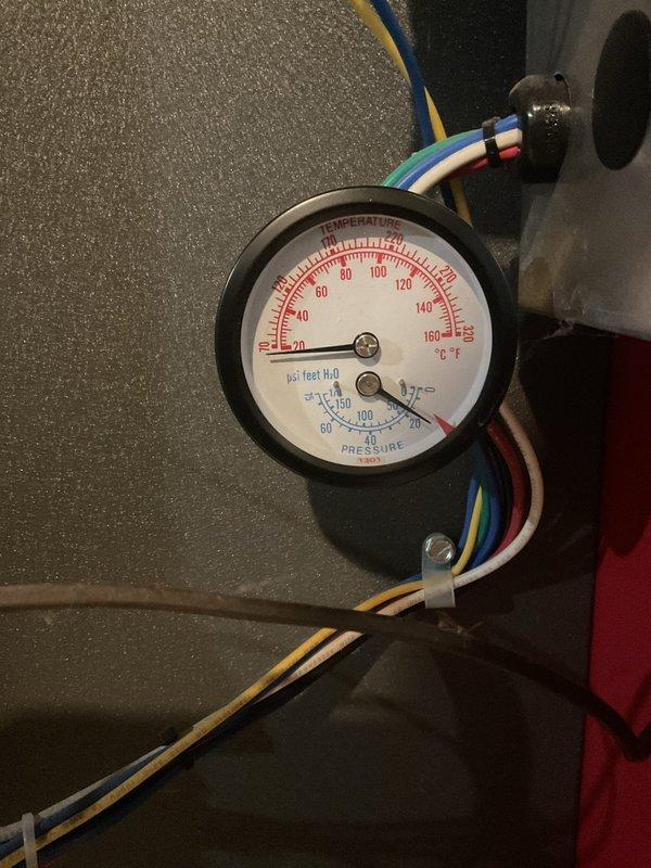 Responded to callback for boiler making loud noise during startup that persisted after previous clean and check service. Upon arrival, inspected boiler system and associated components including pressure/temperature gauges, expansion tank, and hydronic piping network. Verified system pressures and temperatures were within normal operating parameters. Investigated noise complaint by cycling boiler through startup sequence multiple times while monitoring equipment operation. Documented current system conditions with photographs of gauge readings and overall installation for service records.