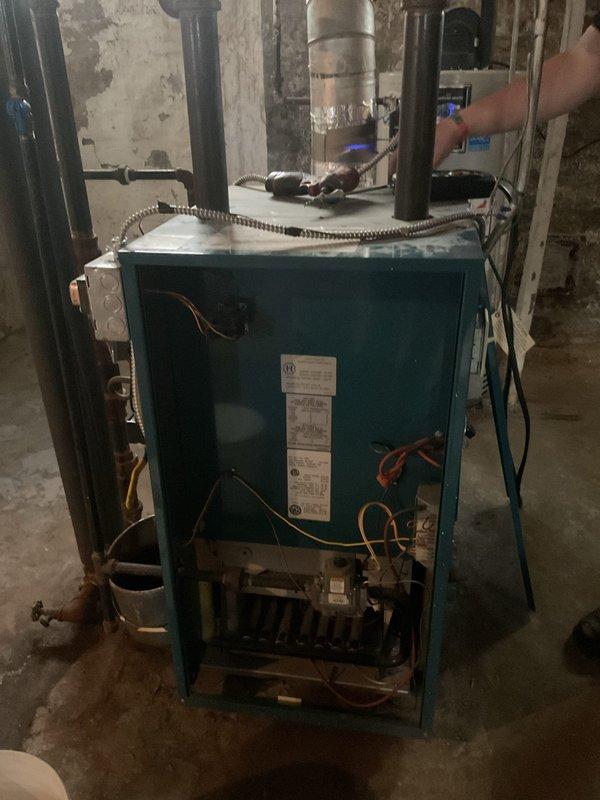 Performed comprehensive tune-up and safety inspection on 2004 Burnham steam boiler system. Conducted thorough cleaning of burner assembly, heat exchanger surfaces, and internal components, removing accumulated debris and ensuring optimal combustion efficiency. Inspected all mechanical components including burner motor, pump mechanism, copper piping connections, and valve operations for proper function. Verified safety controls, electrical connections, and viewing port condition, confirming all systems operating within manufacturer specifications.
