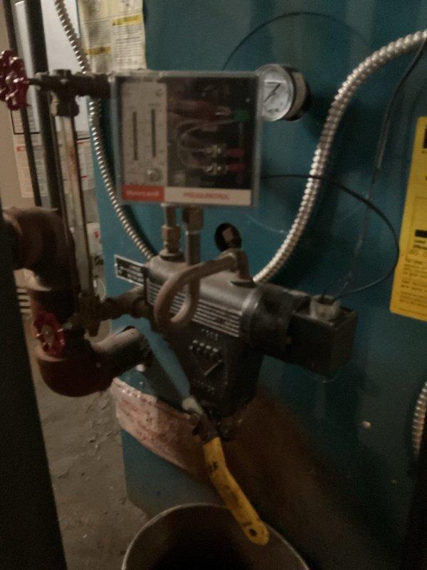 Performed comprehensive tune-up and safety inspection on 2004 Burnham steam boiler system. Conducted thorough cleaning of burner assembly, heat exchanger surfaces, and internal components, removing accumulated debris and ensuring optimal combustion efficiency. Inspected all mechanical components including burner motor, pump mechanism, copper piping connections, and valve operations for proper function. Verified safety controls, electrical connections, and viewing port condition, confirming all systems operating within manufacturer specifications.