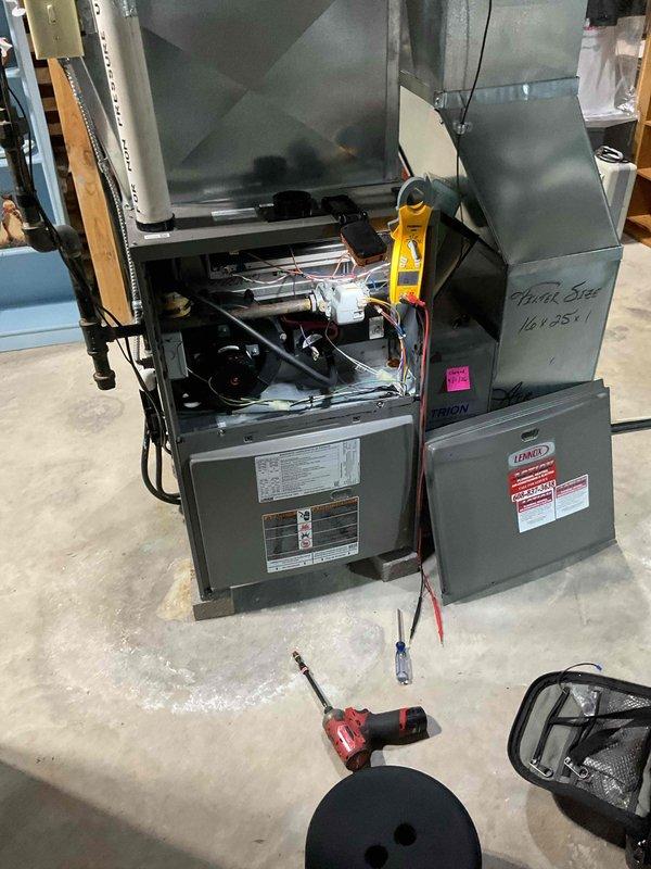 Performed a furnace tune-up and safety inspection on a Lennox gas furnace, cleaning the flame sensor, servicing the condensate drain trap, tightening electrical connections, and blowing out the pressure switch. Testing showed the igniter reading 43 ohms and carbon monoxide output at 9 ppm, with the unit operating normally and heating adequately.