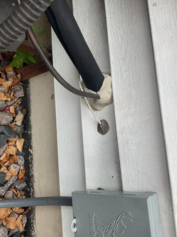 Exposed the refrigerant lineset and the wall penetration at the outdoor unit and found the opening into the home was not properly sealed. Sealed the lineset penetration with sealant to close the gap and prevent air and moisture infiltration.