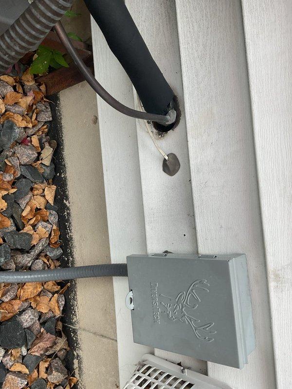 Exposed the refrigerant lineset and the wall penetration at the outdoor unit and found the opening into the home was not properly sealed. Sealed the lineset penetration with sealant to close the gap and prevent air and moisture infiltration.