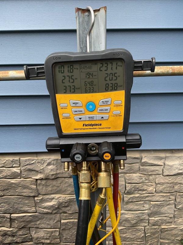 Responded to a reported no-cooling complaint on a recent new installation and connected a digital refrigerant manifold to evaluate system operation. Refrigerant readings on the R454B system were within acceptable range (approximately 102 psig low side, 237 psig high side, 20.5°F subcooling), and the air handler blower speed was reduced to correct the airflow and cooling performance issue. The system was confirmed operating properly at completion.