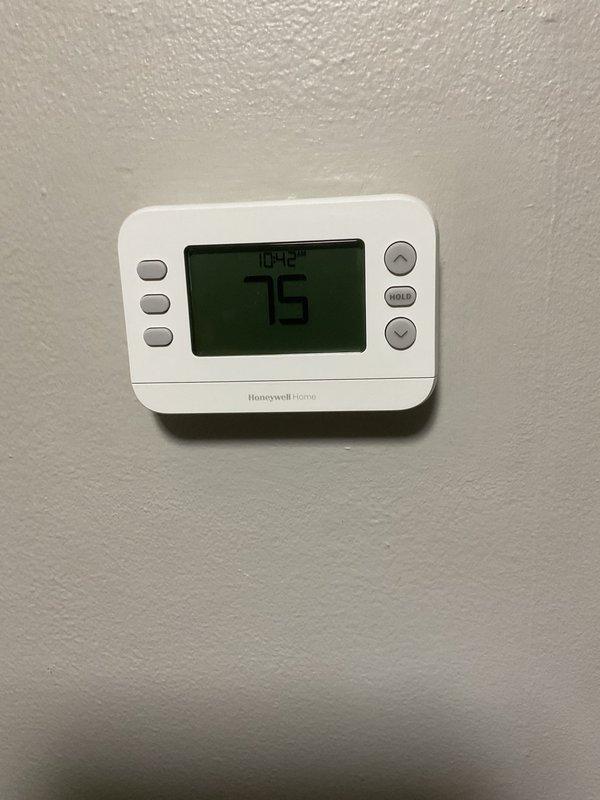 Diagnosed a no-heat and no-cooling call with a thermostat displaying "No Power" despite fresh batteries, and found the thermostat wiring had been incorrectly terminated. Rewired the Honeywell thermostat to the proper terminals, restoring power to the display, then cycled the system and confirmed the Ruud Silhouette II furnace started and ran a normal heating cycle. Inspected the furnace and air filter during the visit, with no additional issues noted.