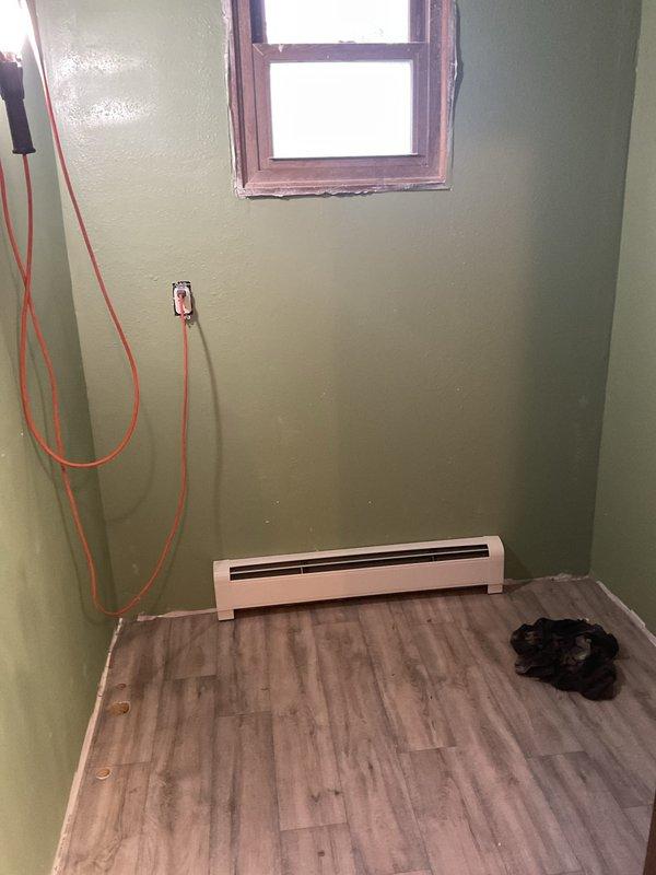 Installed a new 3-foot electric baseboard heater in the existing location along the exterior wall, securing it at the proper clearance above the finished flooring. Connected the unit to the existing line-voltage supply, verified secure terminations, and tested operation to confirm proper heat output and thermostat response.