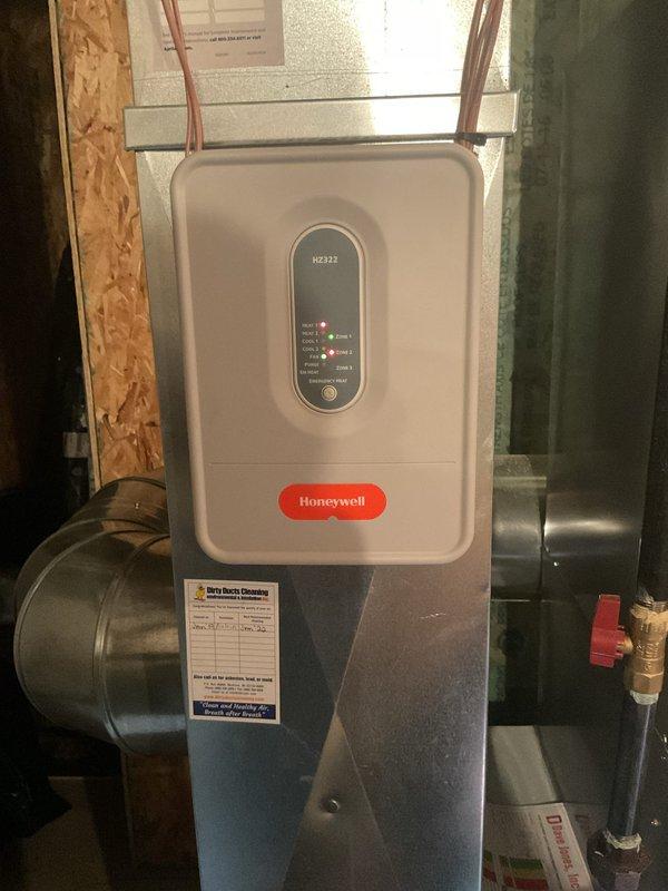 Performed a cleaning and operational inspection on a 2016 Bryant furnace, including a basic cleaning and system check. Inspected the associated zone control components, including the Honeywell HZ322 zone control panel and damper actuators on the ductwork, and verified proper panel indication and wiring connections with no visible damage, rust, or frost observed.