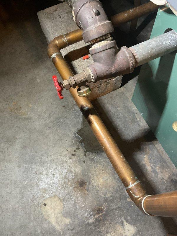 Responded to a boiler leak reported following a recent maintenance visit and traced the source to the boiler drain valve on the side of the unit. Capped the boiler drain with a drain cap to stop the leak and secure the system.