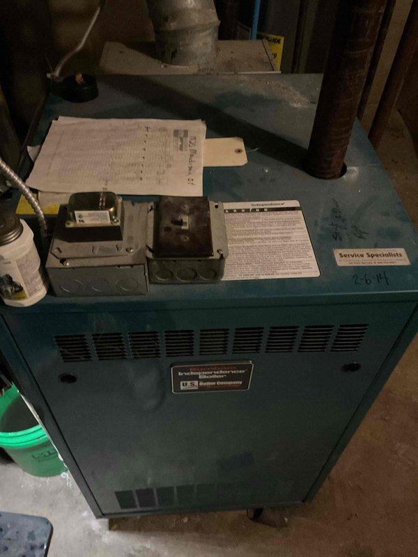 Gained access to the Burnham Independence boiler by forcing open the thermostat lock box, as no key was available. Replaced the non-functioning pressure gauge and tested system operation. The boiler ran, but the new gauge still showed no pressure reading, so the cause of the missing reading remains unresolved and further diagnosis of the gauge connection or system is recommended.